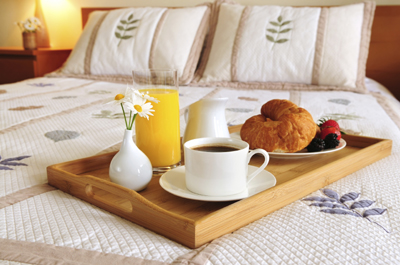 Breakfast on a bed in a hotel room Breakfast on a bed in a hotel room