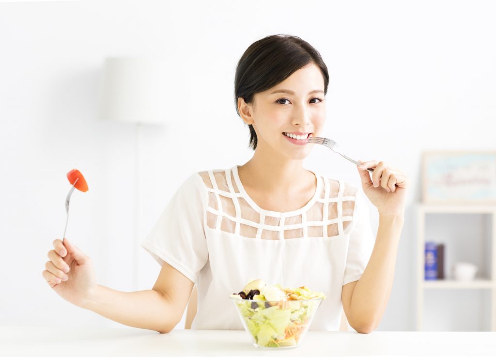 beautiful young woman eating healthy food