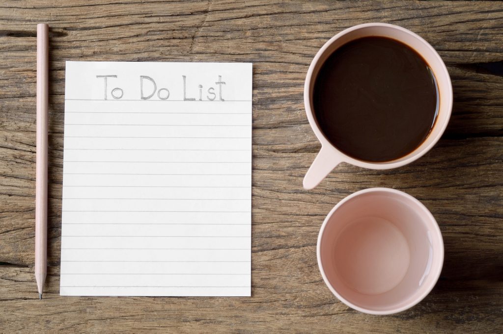to do list word on wooden table with coffee cup, drinking water and pencil