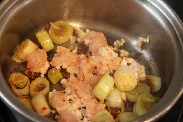 香りがたったら、ひき肉を入れて炒める。