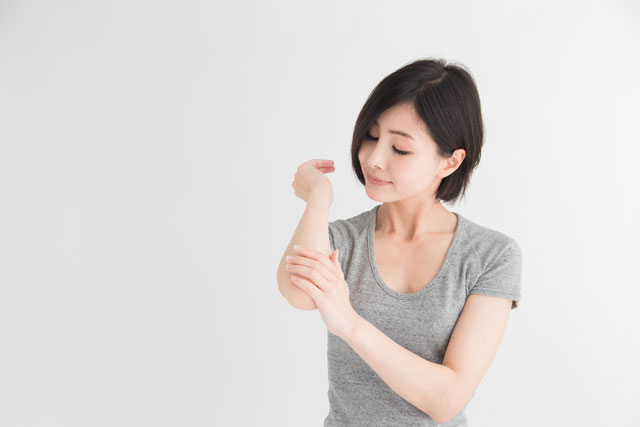 肘をケアする女性