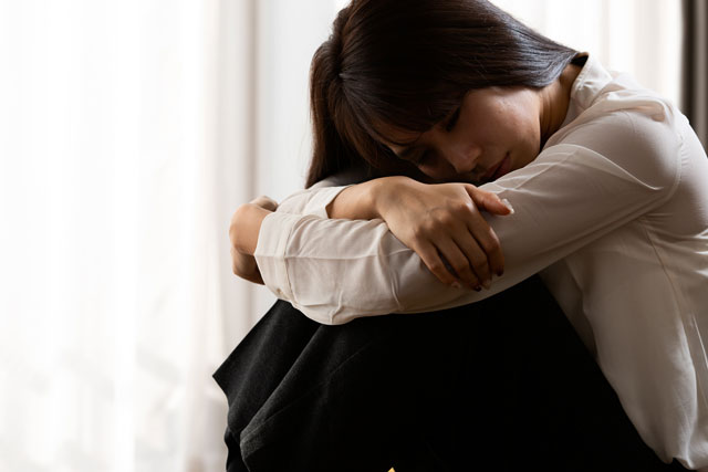 体調の悪い女性